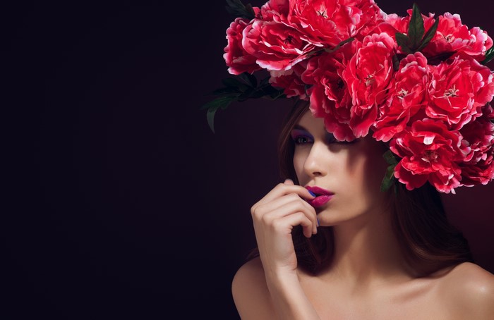 Model with flower wreath and vibrant makeup