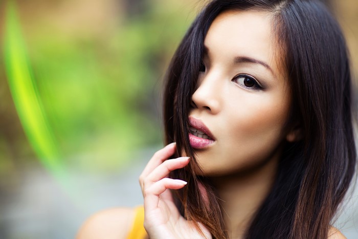 Asian woman with dark hair and makeup
