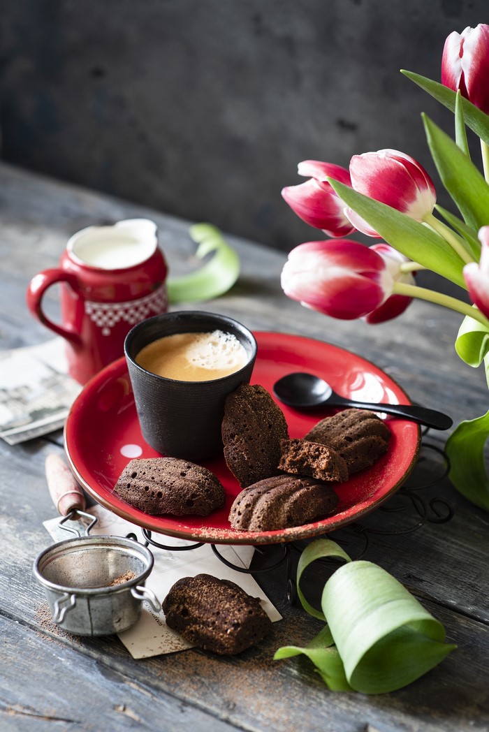 Chocolate madeleines with coffee and tulips