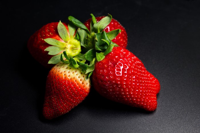 Four Strawberries on a Dark Background
