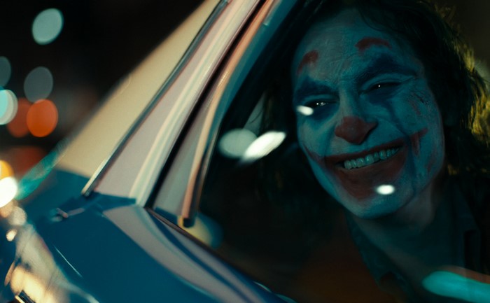 Joker in a car at night