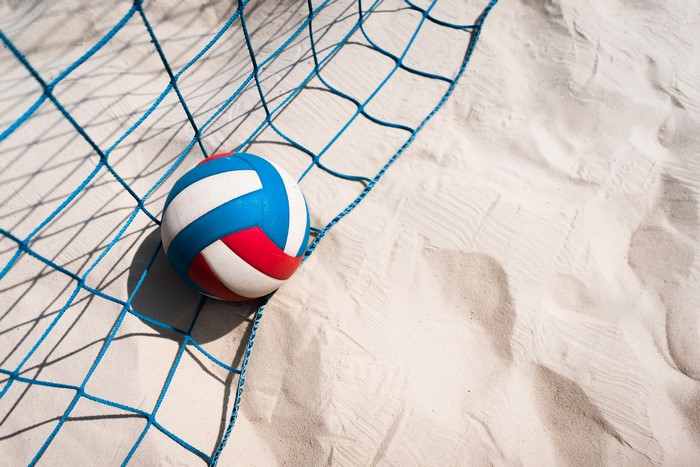 Volleyball on a sandy beach near a net