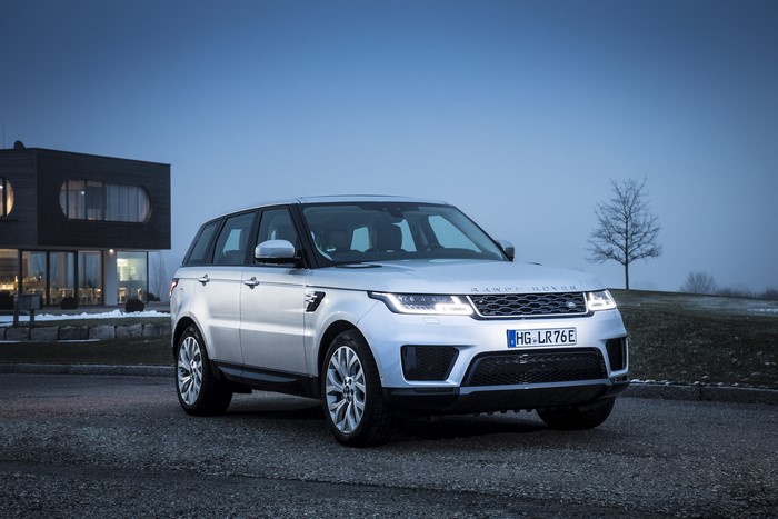 Silver Range Rover Sport P400e HSE parked near a modern house