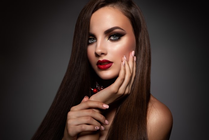 Model with dramatic makeup and red lipstick