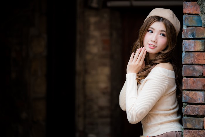 Asian woman with brown hair wearing a beret