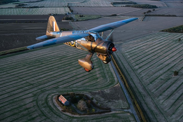Westland Lysander Mk.IIITT airplane flying over farmland
