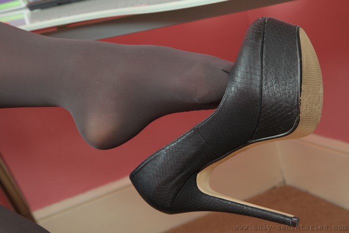 Woman's leg in pantyhose with black stiletto heel