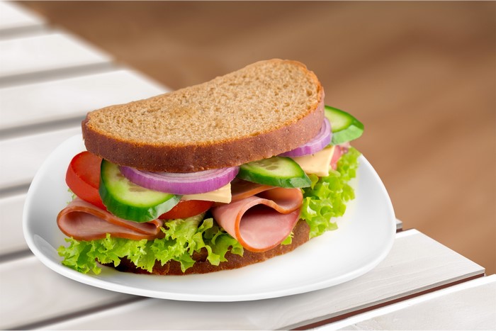 Sandwich with ham and vegetables on a plate
