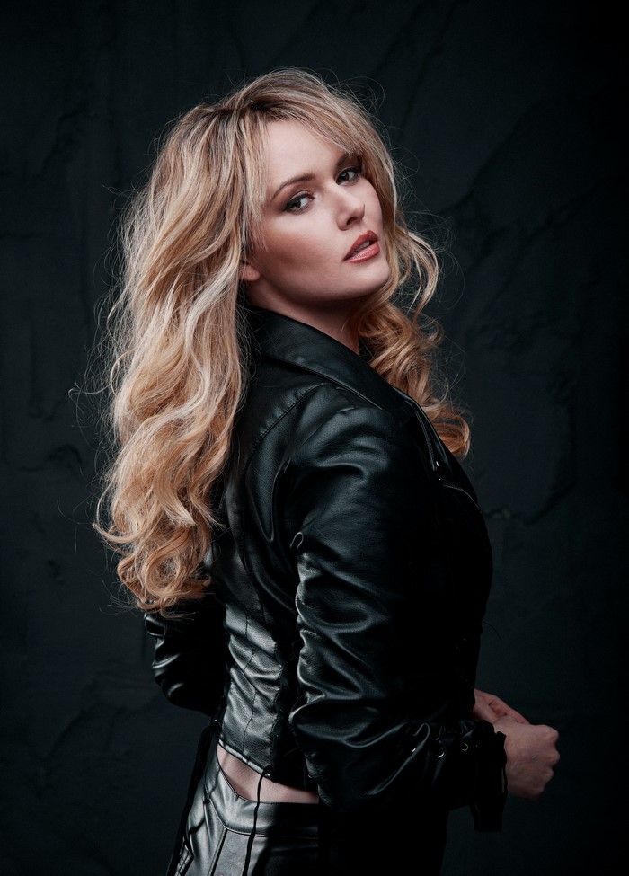 Carla Monaco blonde woman in leather jacket