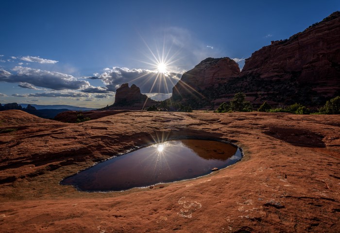 Sunburst through Arch Rock in Sedona, Arizona