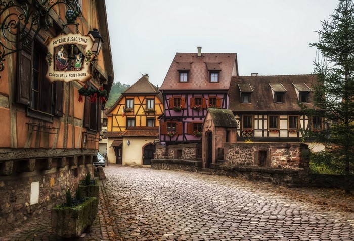 Cobblestone street in Kaysersberg, France with traditional houses