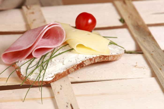 Bread with ham, cheese, tomato, and chives