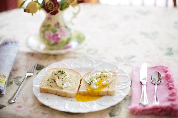 Poached eggs on toast with a vase of flowers