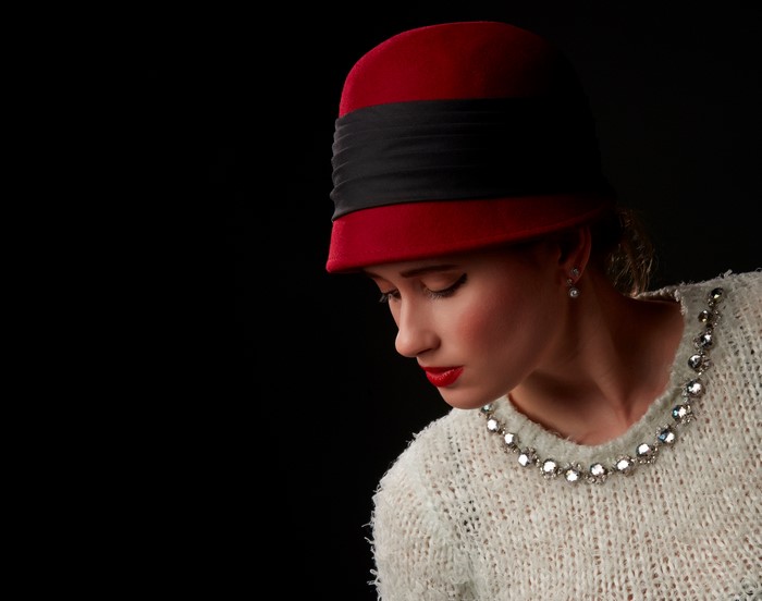 Woman in red hat and sweater with red lips