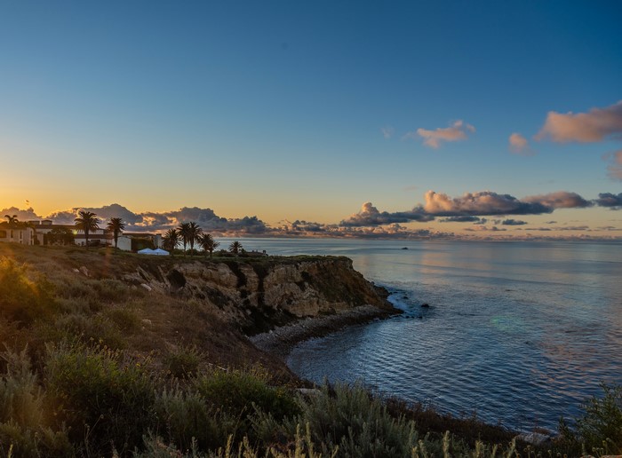 Coastal cliff overlooking the ocean at sunset in California