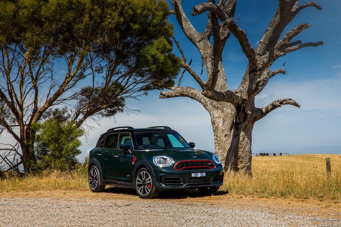 Green Mini John Cooper Works Countryman parked by trees