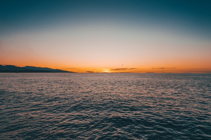 Sunset over the Sea with Mountains