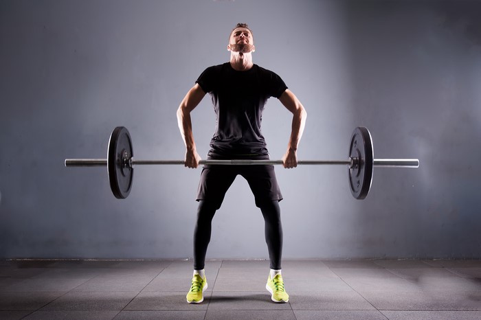 Man lifting barbell in gym