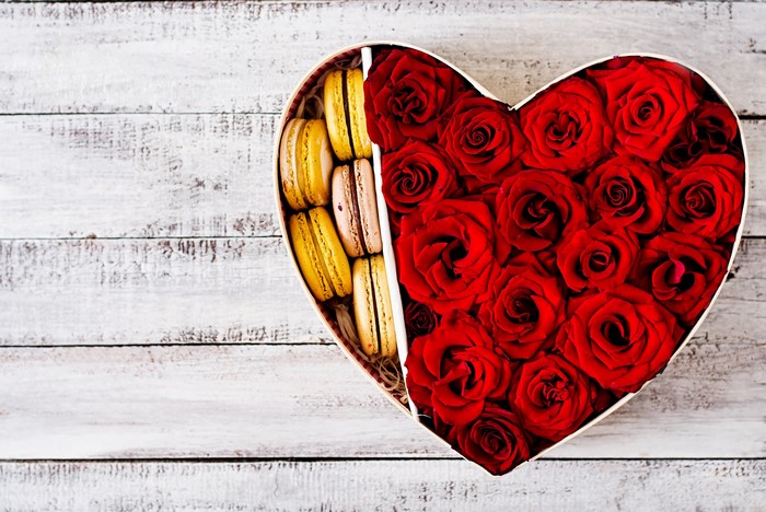 Heart-shaped box with red roses and macarons