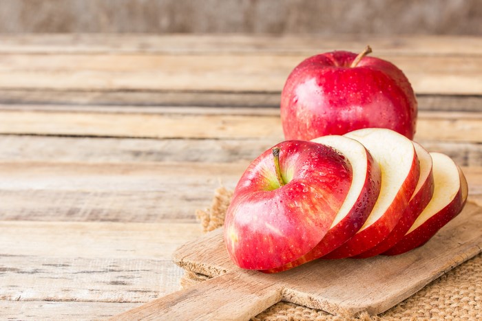 Red Apples Sliced on Cutting Board