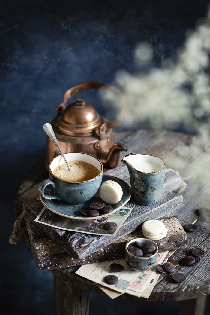 Coffee, chocolate, macarons, and milk with a kettle