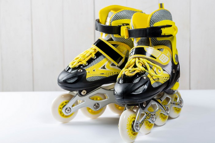 Yellow and black inline roller skates