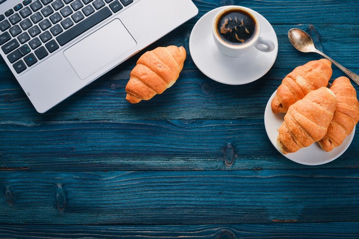 Coffee and Croissants with Laptop on Wood