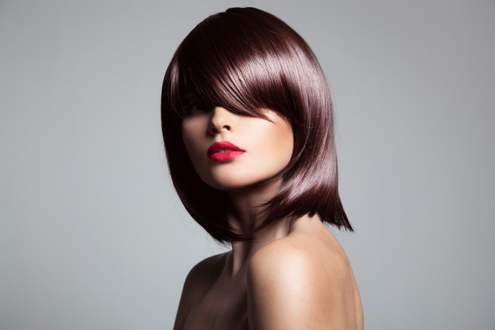 Model with brown hair and red lipstick