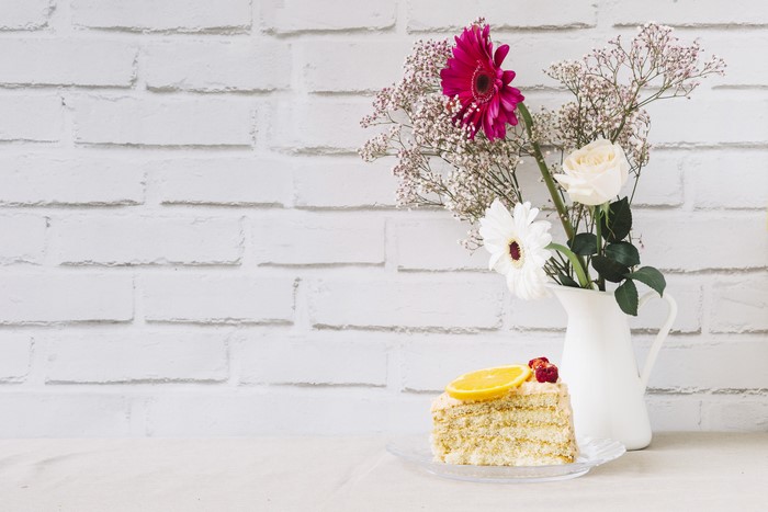 Slice of cake with flowers in a vase
