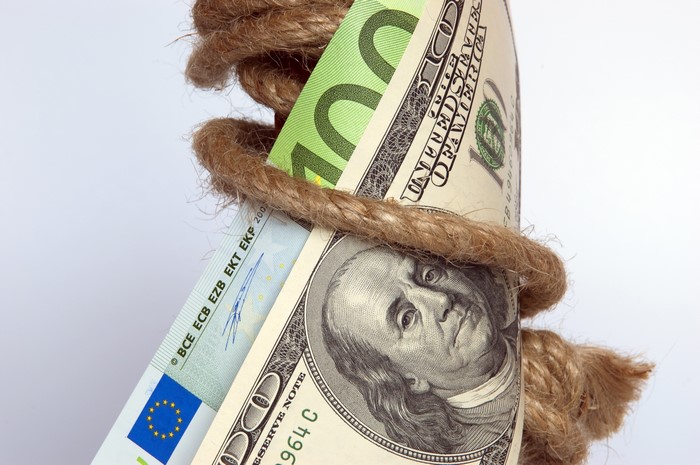 US Dollars and Euros bound by rope