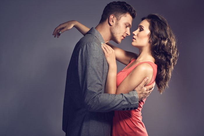 Couple embracing in formal and casual wear