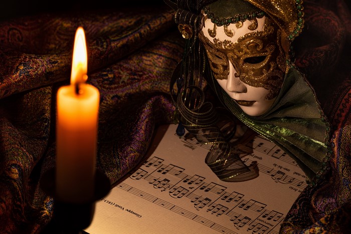 Venetian Mask and Sheet Music by Candlelight