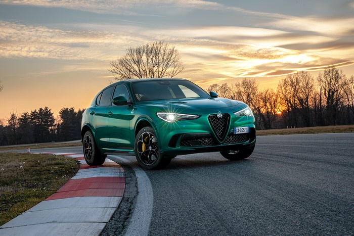 Green Alfa Romeo Stelvio Quadrifoglio on a track at sunset