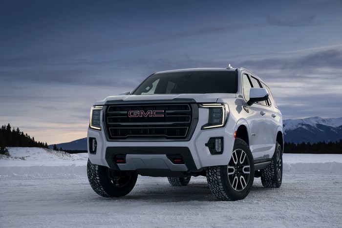 White GMC Yukon AT4 SUV in Snow