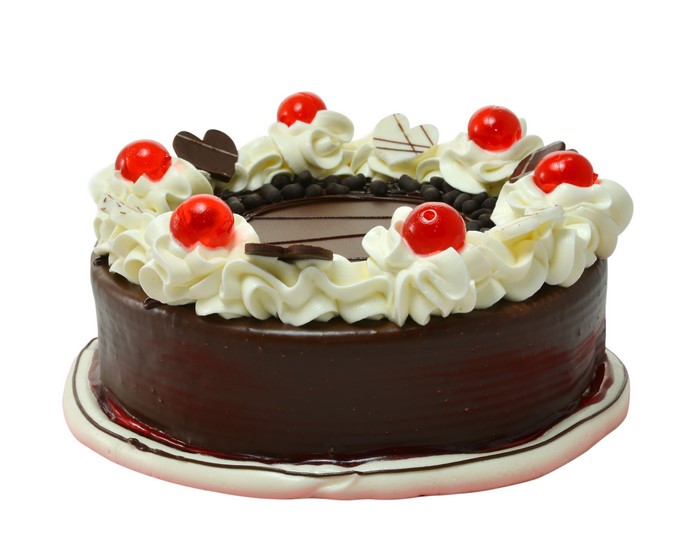 Chocolate cake with whipped cream and cherries