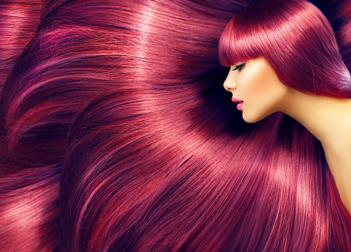 Woman with long, shiny, magenta hair
