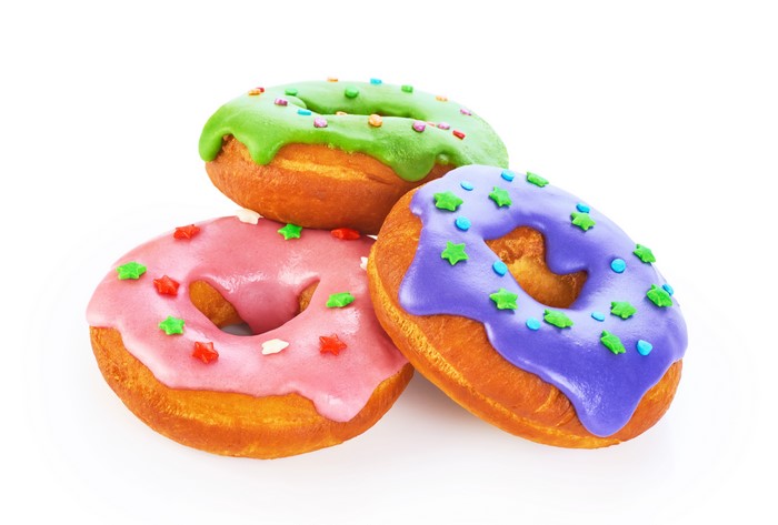 Three donuts with icing and star decorations