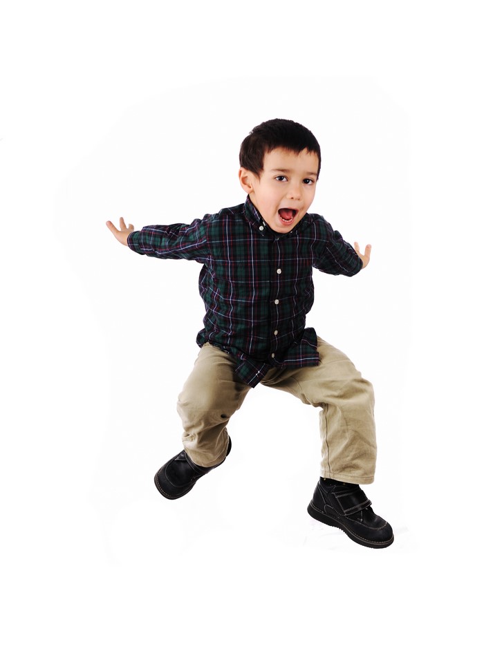 Boy jumping with arms outstretched