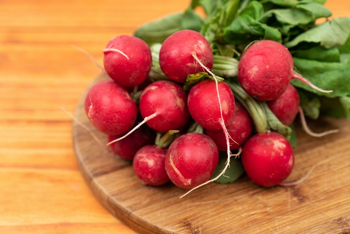 Radishes on a wooden cutting board