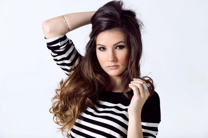 Brown haired woman with makeup and jewelry