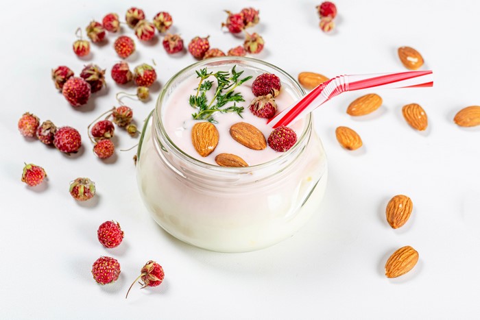 Yogurt with strawberries and almonds in a jar
