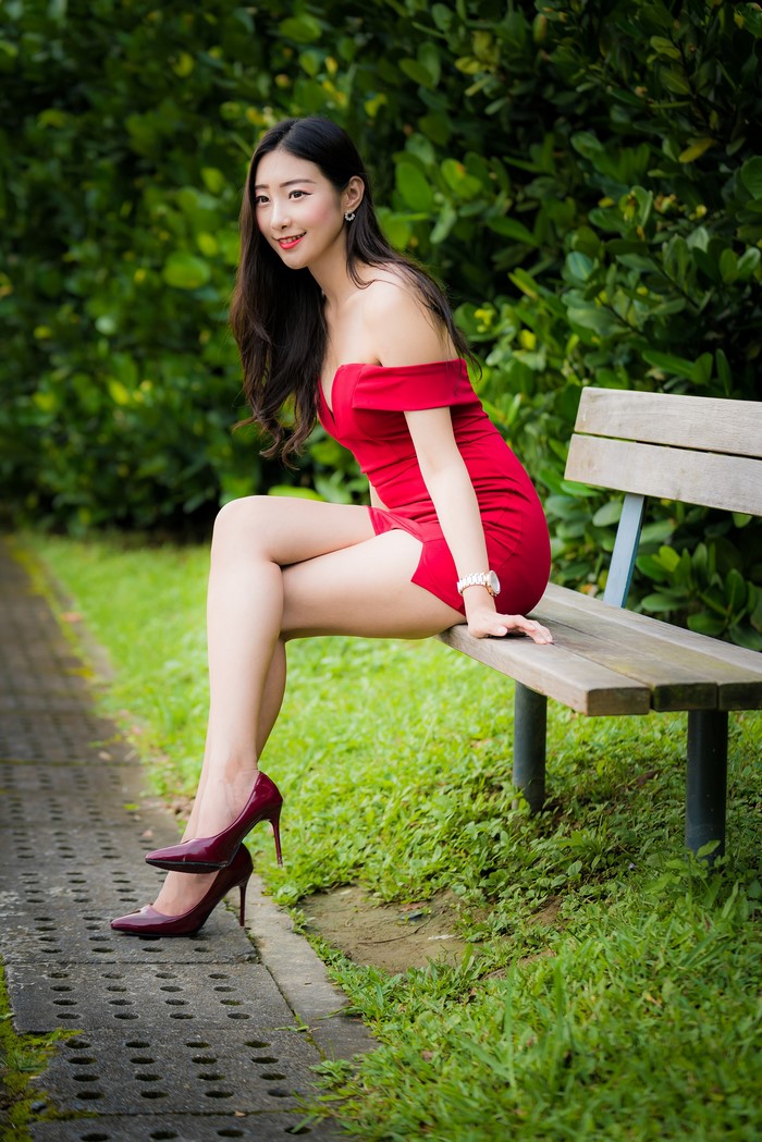 Asian Woman in Red Dress Sitting on Bench