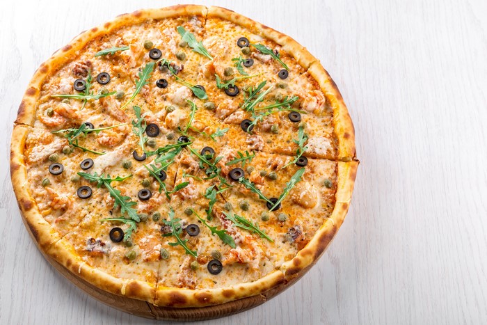Pizza with olives and arugula