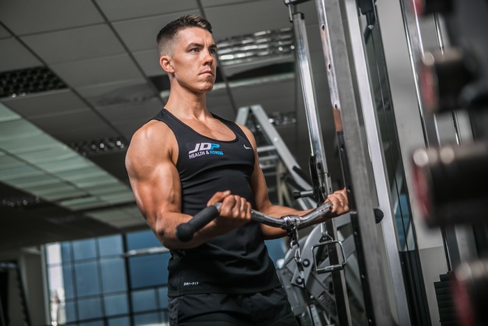 Man performing bicep curls at the gym