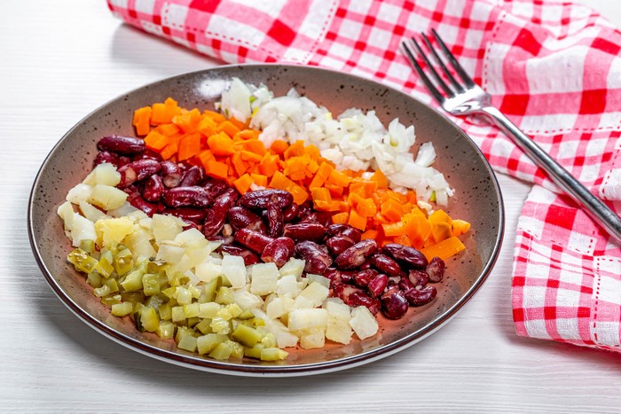 Diced salad ingredients on a plate with a fork