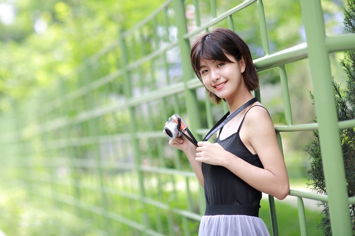 Asian girl with camera smiling