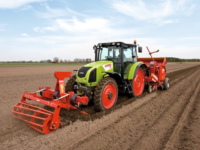 Claas Axos 340 tractor plowing a field