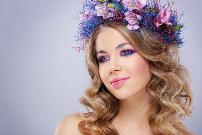 Beautiful model with flower wreath and curly hair