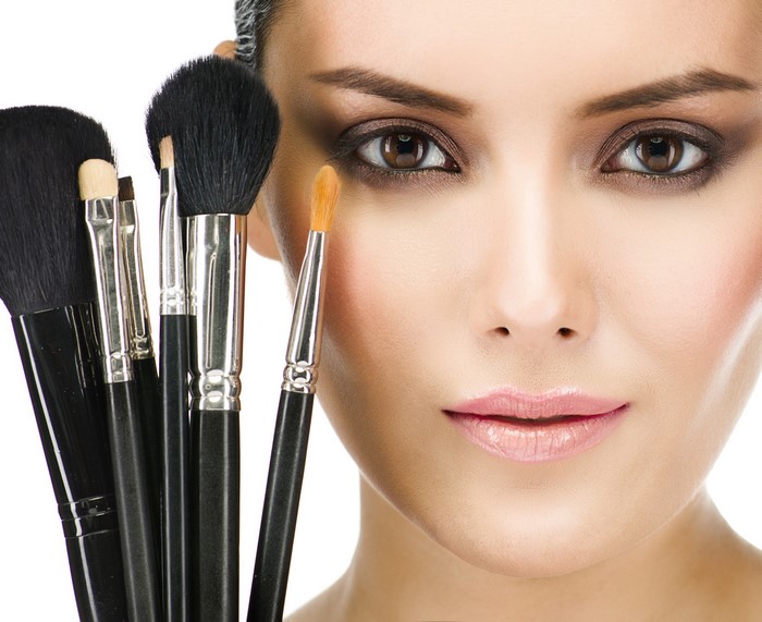 Woman with makeup brushes