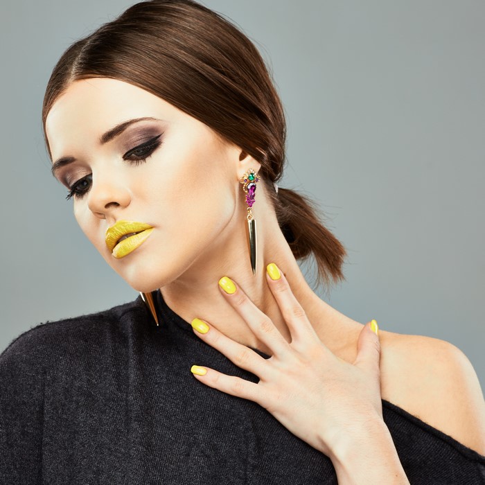 Woman with yellow lipstick and earrings